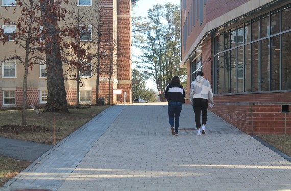 Two students walking in quad